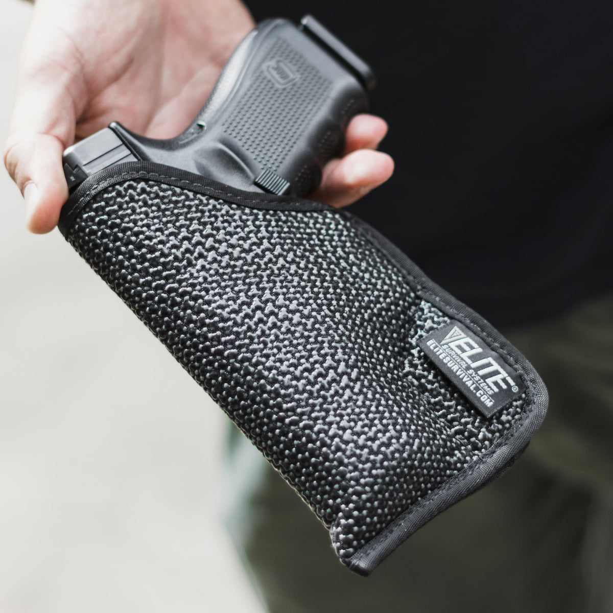 Hand holding the Mainstay Clipless IWB holster