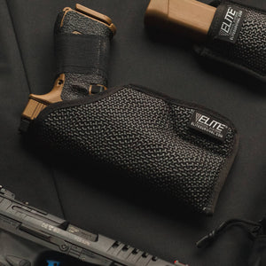 Black gun holster with Elite branding on a dark surface
