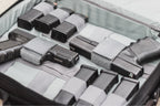 Collection of black firearms and magazines in a gray case