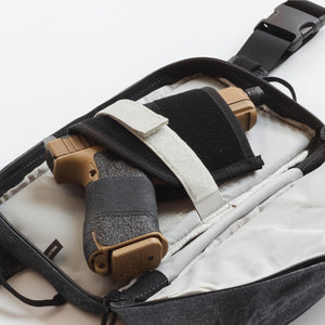 Close-up of a tactical holster with a gun inside on a white background
