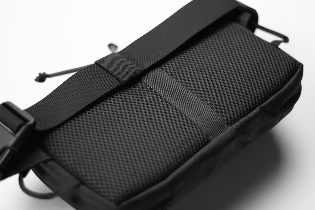 Black tactical pouch with mesh side on a white background
