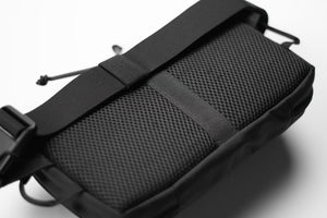 Black tactical pouch with mesh side on a white background