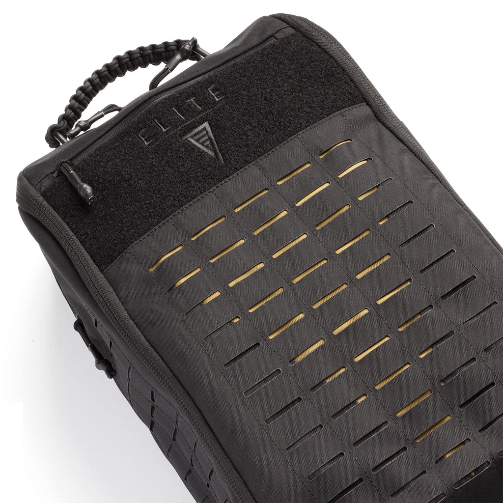 Close-up of a black tactical backpack or gear bag with a woven strap handle, a black Velcro panel with the ELITE logo, and a front zipper featuring horizontal cutout slats on a white background.