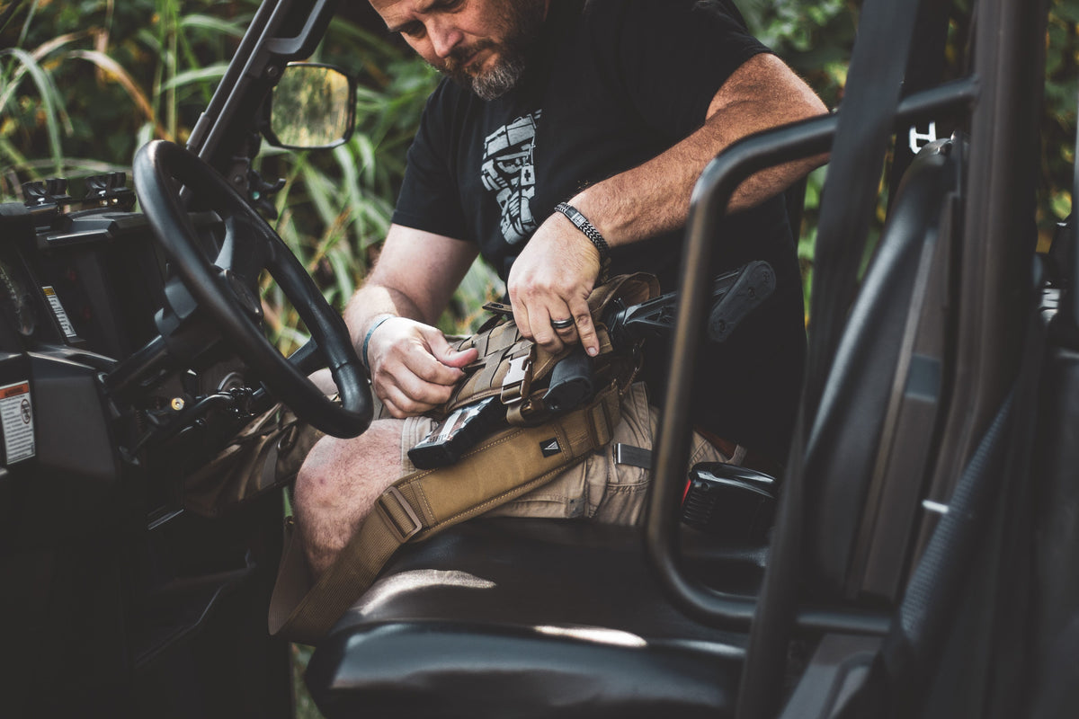 Man working on a vehicle in a natural setting