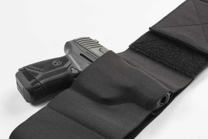 Black gun holster with a handgun on a white background