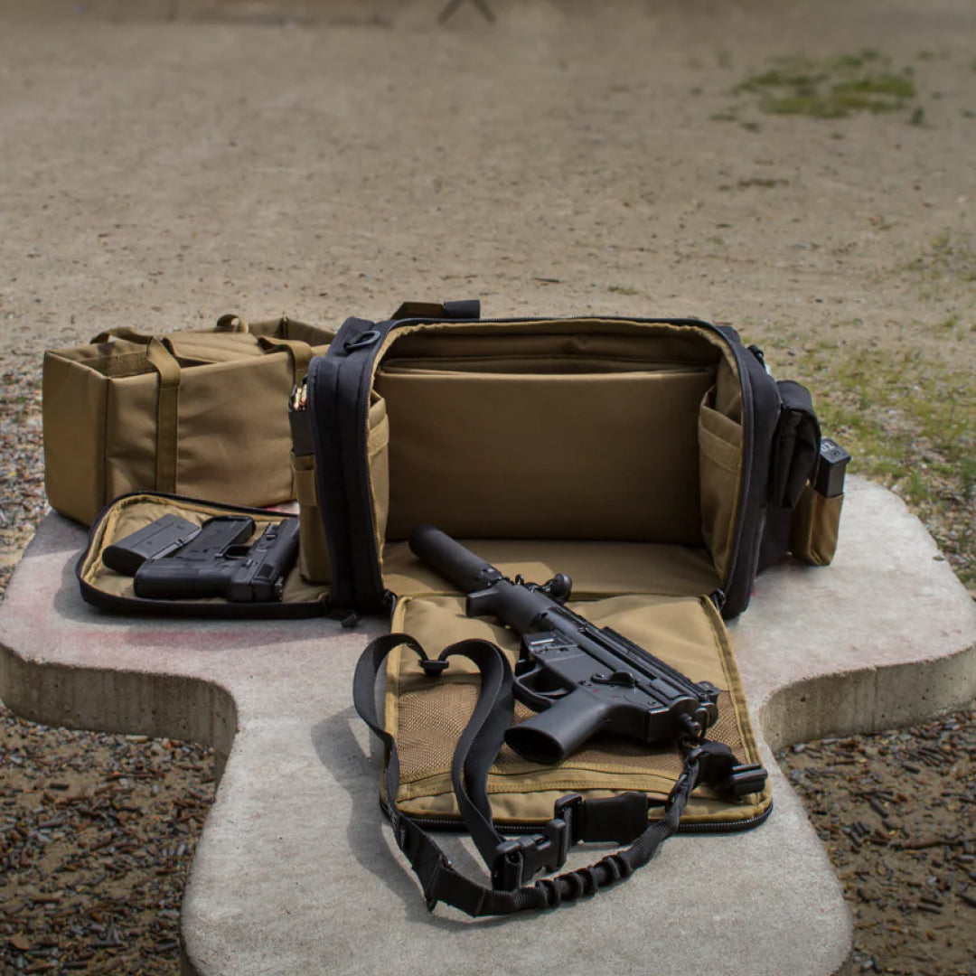 Tactical bag with rifle and equipment on a concrete surface