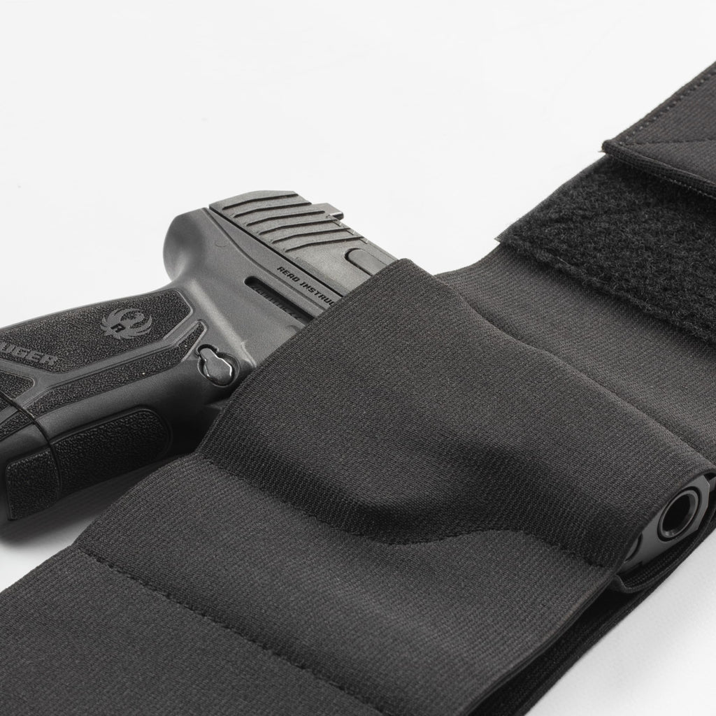 Black gun holster with a handgun on a white background