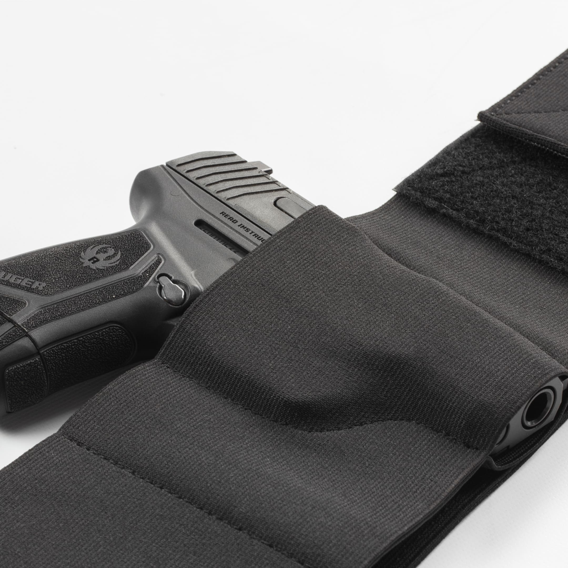 Black gun holster with a handgun on a white background
