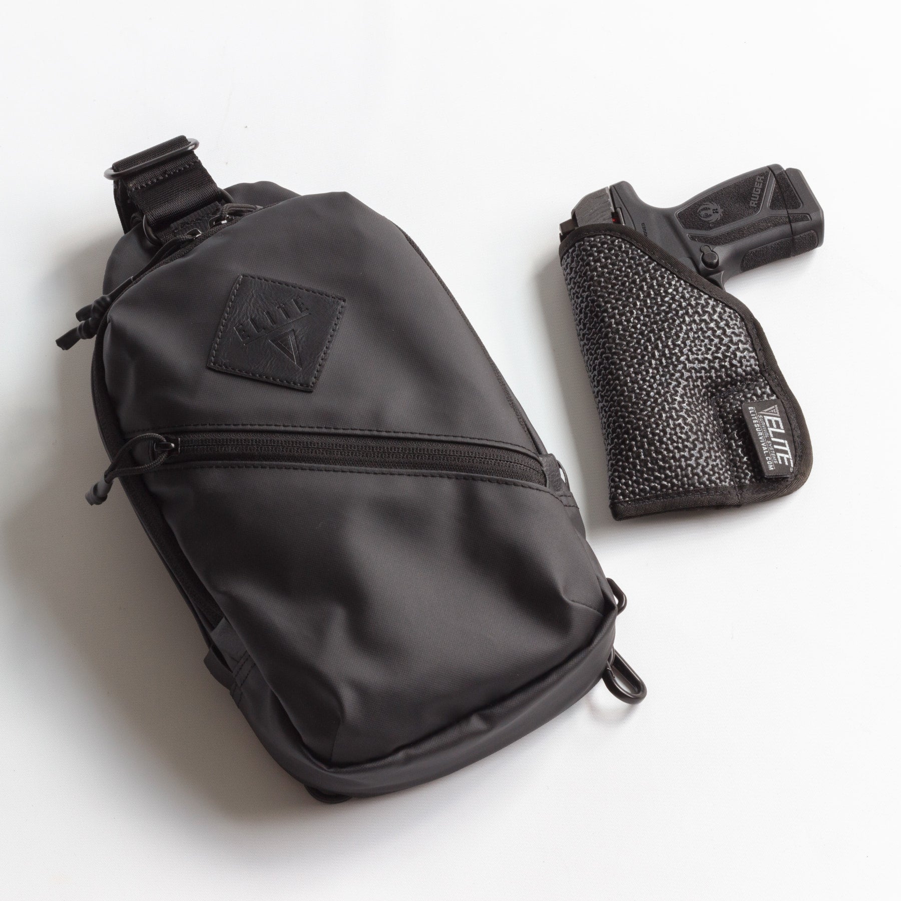 Black sling bag and gun holster on a white background