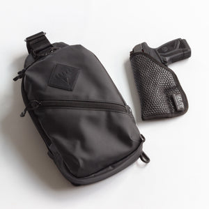 Black sling bag and gun holster on a white background