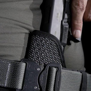 Close-up of a person holding a knife with a tactical sheath.