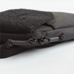 Close-up of a black tactical pouch with a zipper on a white background