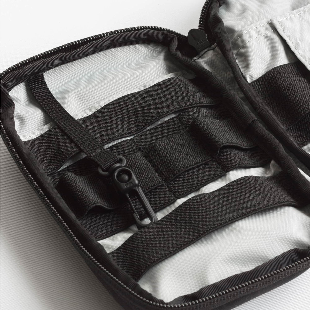 Close-up of a black strap and buckle on a white background