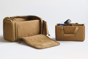 Brown travel bag with compartments on a white background
