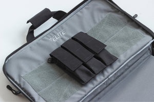 Gray tactical bag with black molle straps on a white background