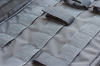 Close-up of a tactical case with multiple straps and patches.