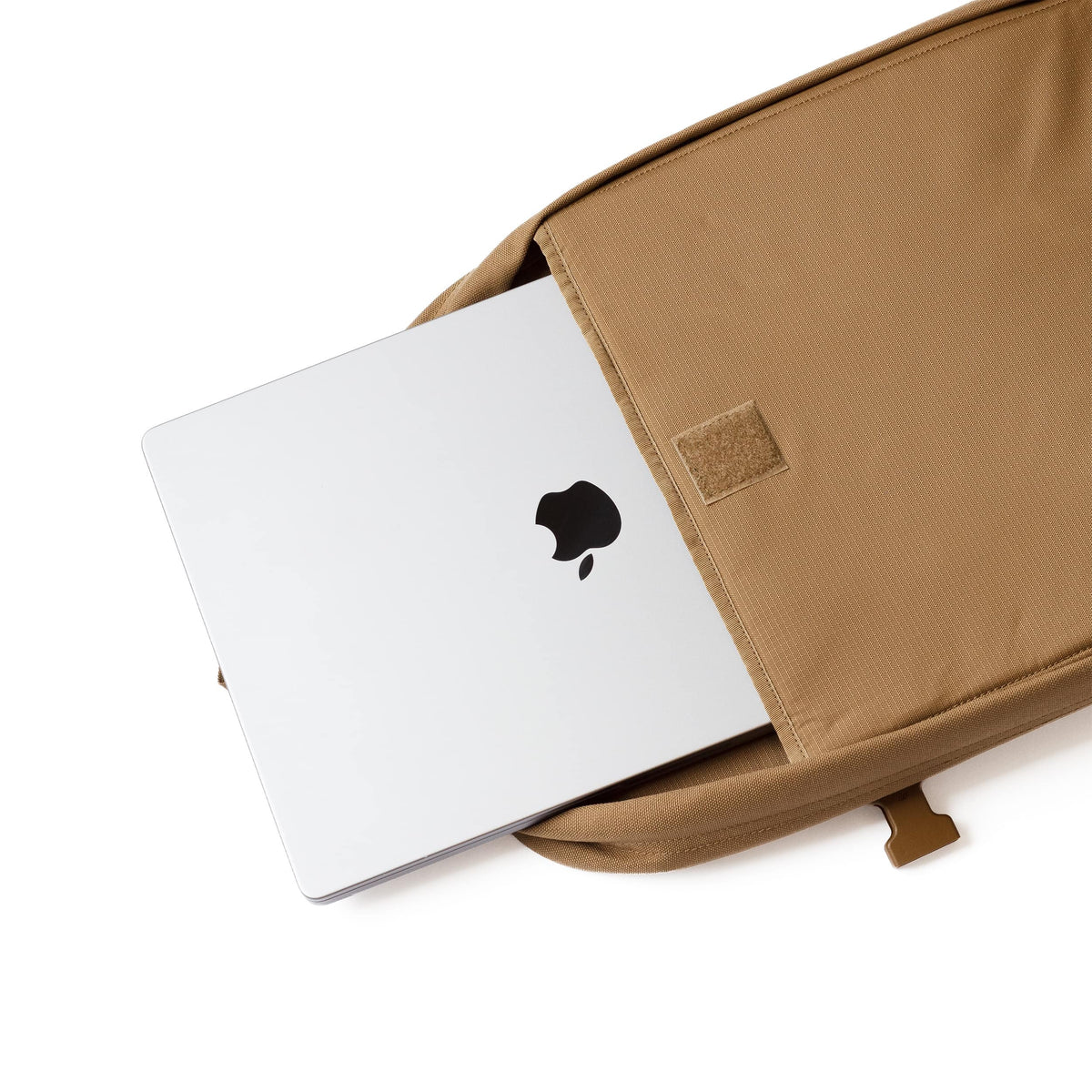Laptop sliding into the padded 17-inch laptop sleeve of the Strike 24-Hour Backpack