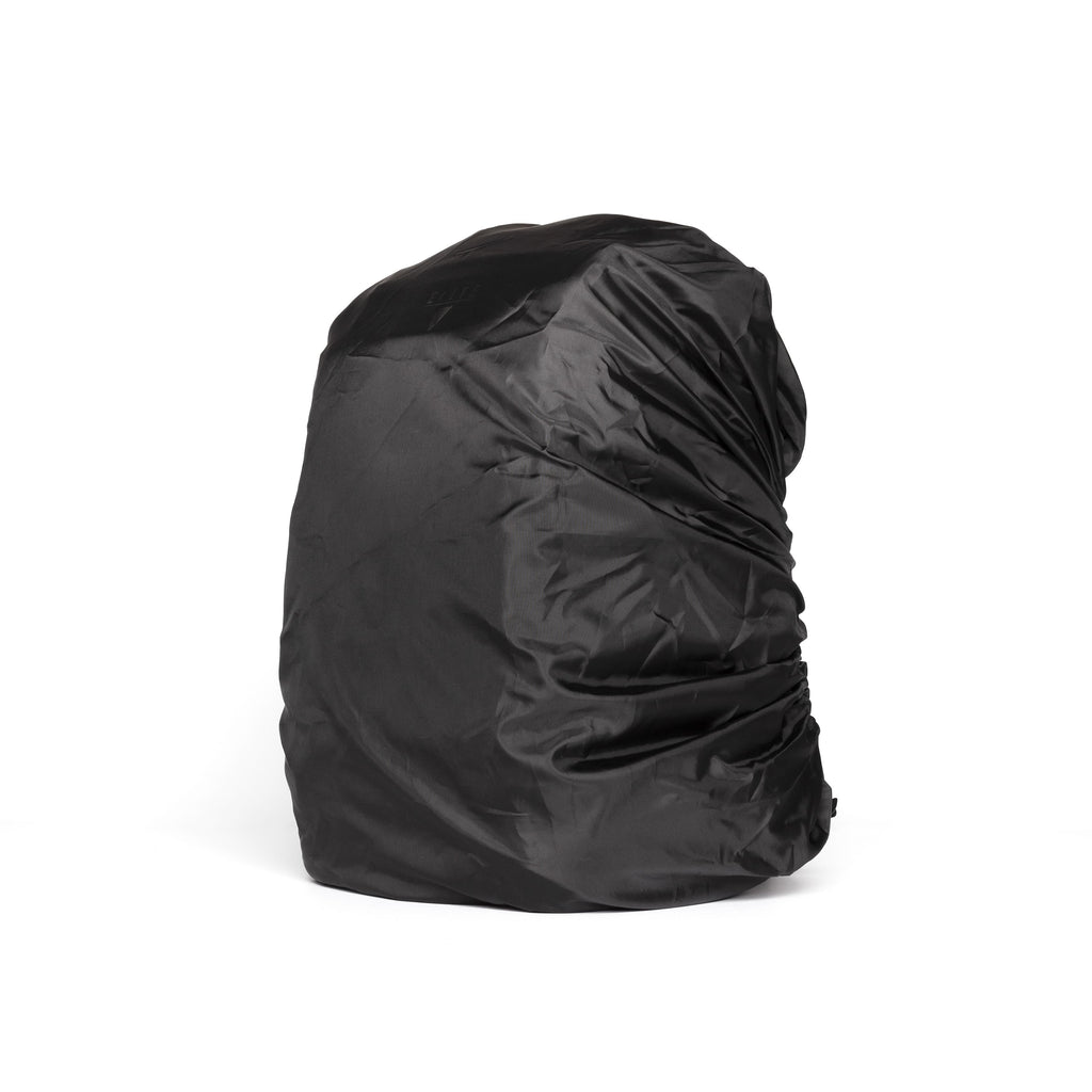 A black waterproof rain cover for a backpack, shown filled and draped on a clean white background.