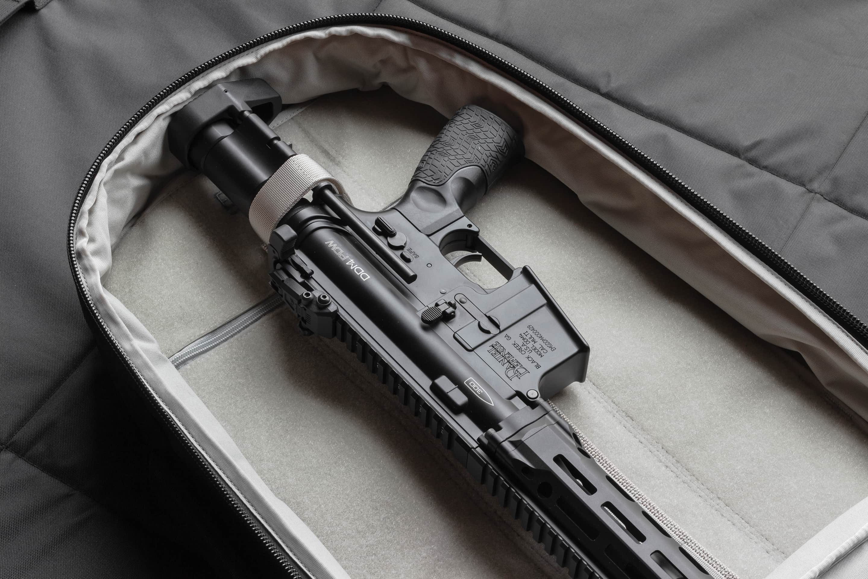 Black rifle inside a gray protective case