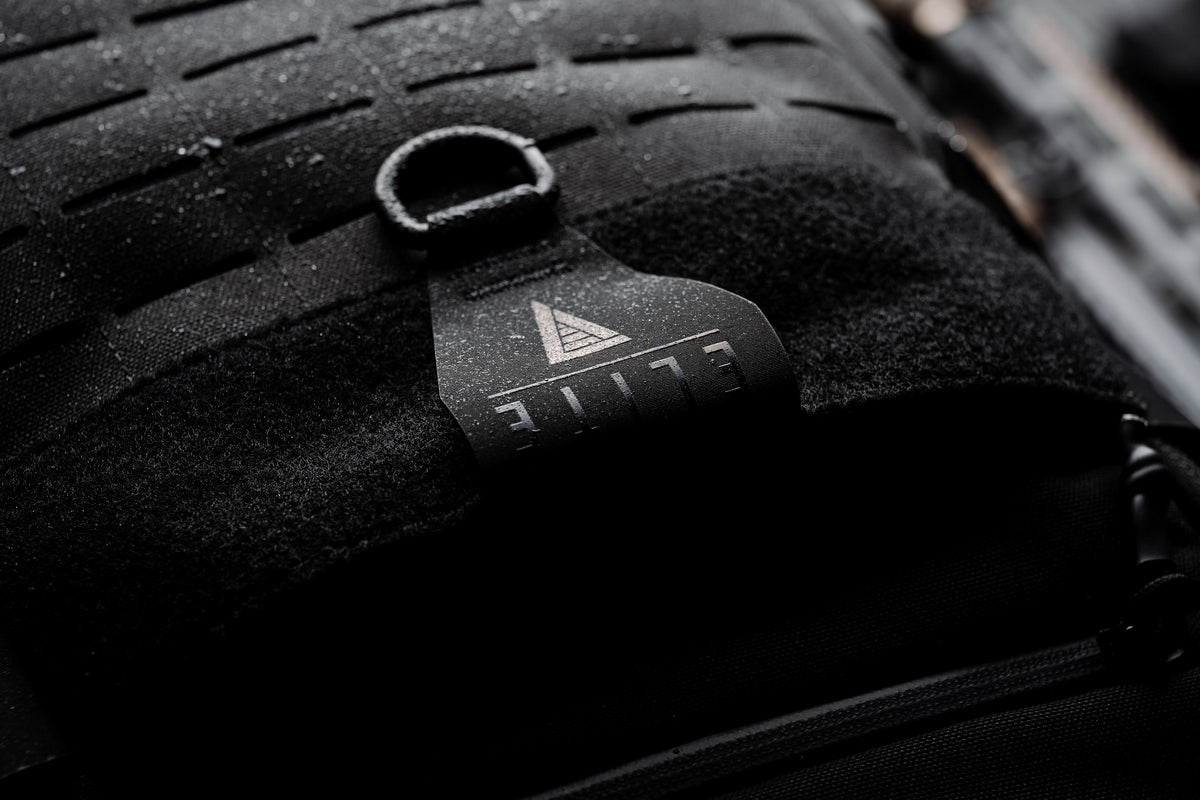 Laser-cut MOLLE front panel, D-ring, and ELITE logo pull tab on the black Mission Backpack 40L