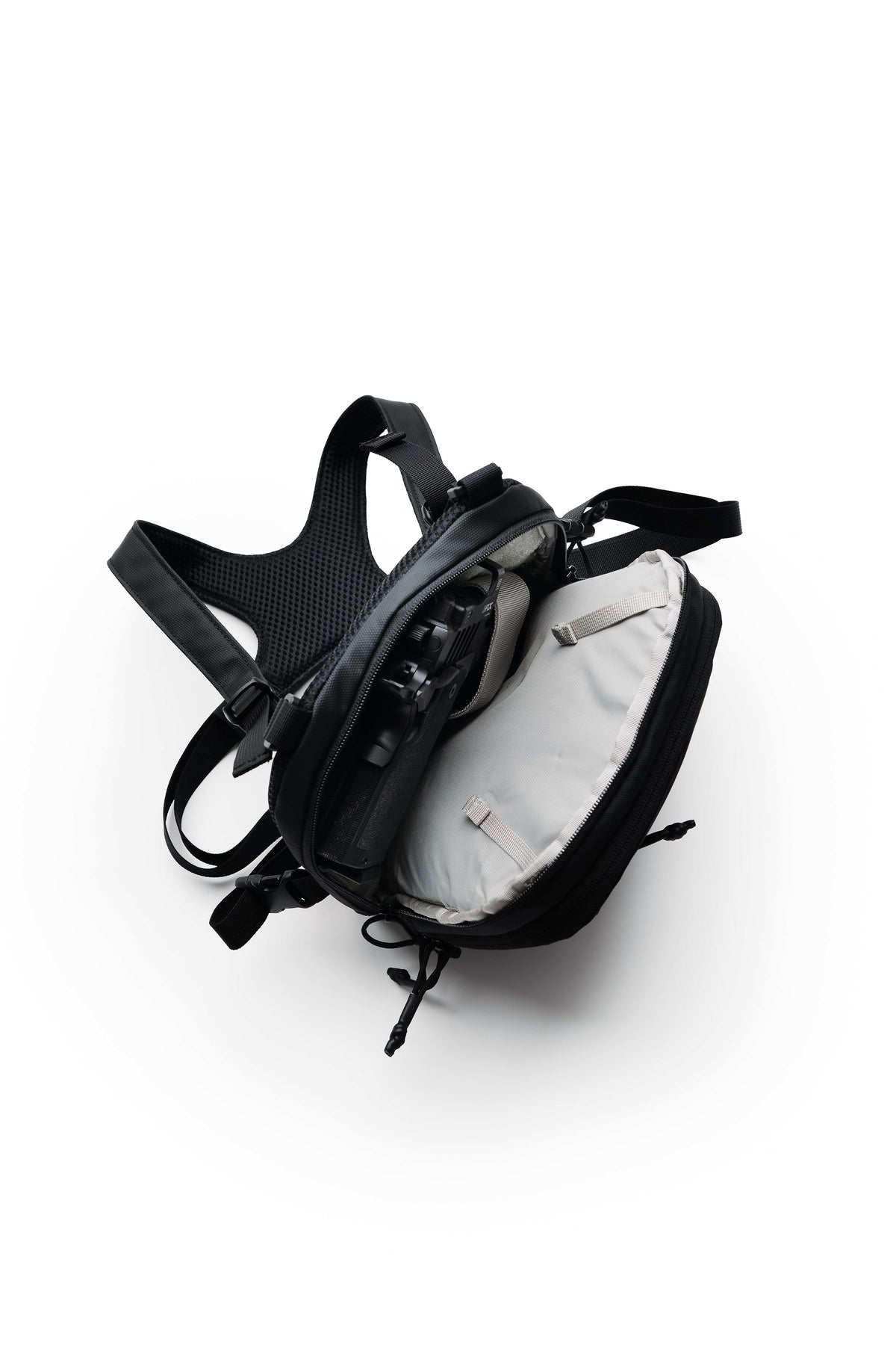 Black TrailGuard Concealed Carry Chest Holster opened to show the gray-lined main compartment and padded harness
