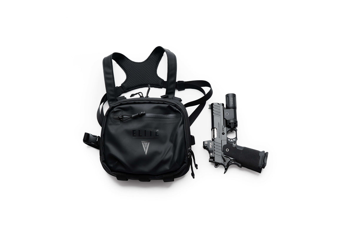 Black TrailGuard Concealed Carry Chest Holster beside a handgun with a mounted weapon light