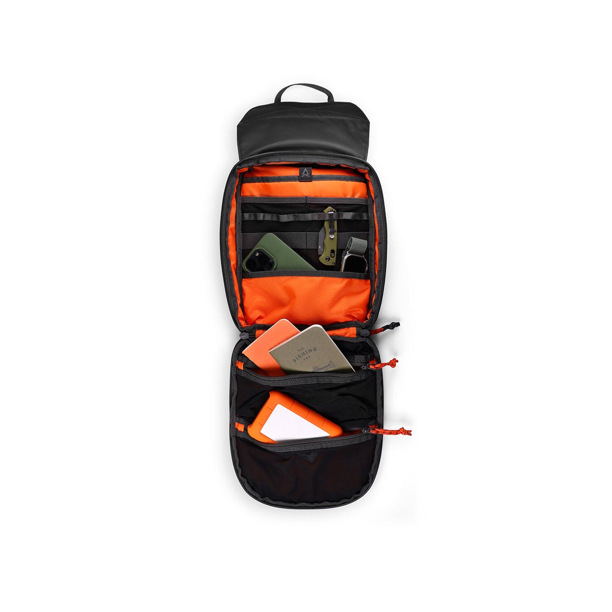 Tech Sling opened flat and packed with tech essentials including a notebook, cards, cables and a slim multi-tool held in the orange interior organizer.