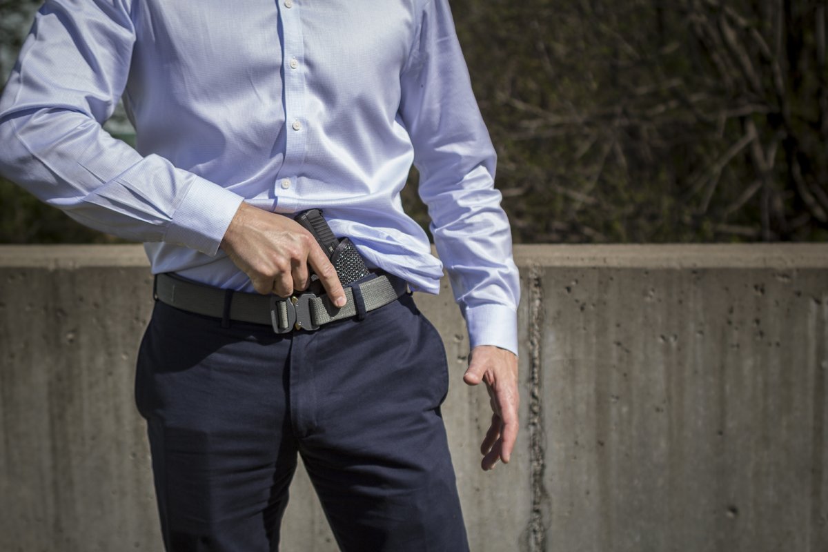 Man with shooters belt drawing gun from Mainstay IWB Holster