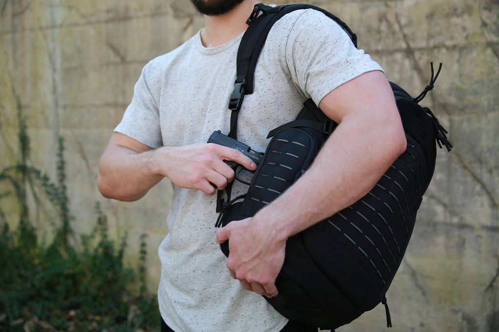 Firearm being drawn from CCW compartment of Guardian Backpack.