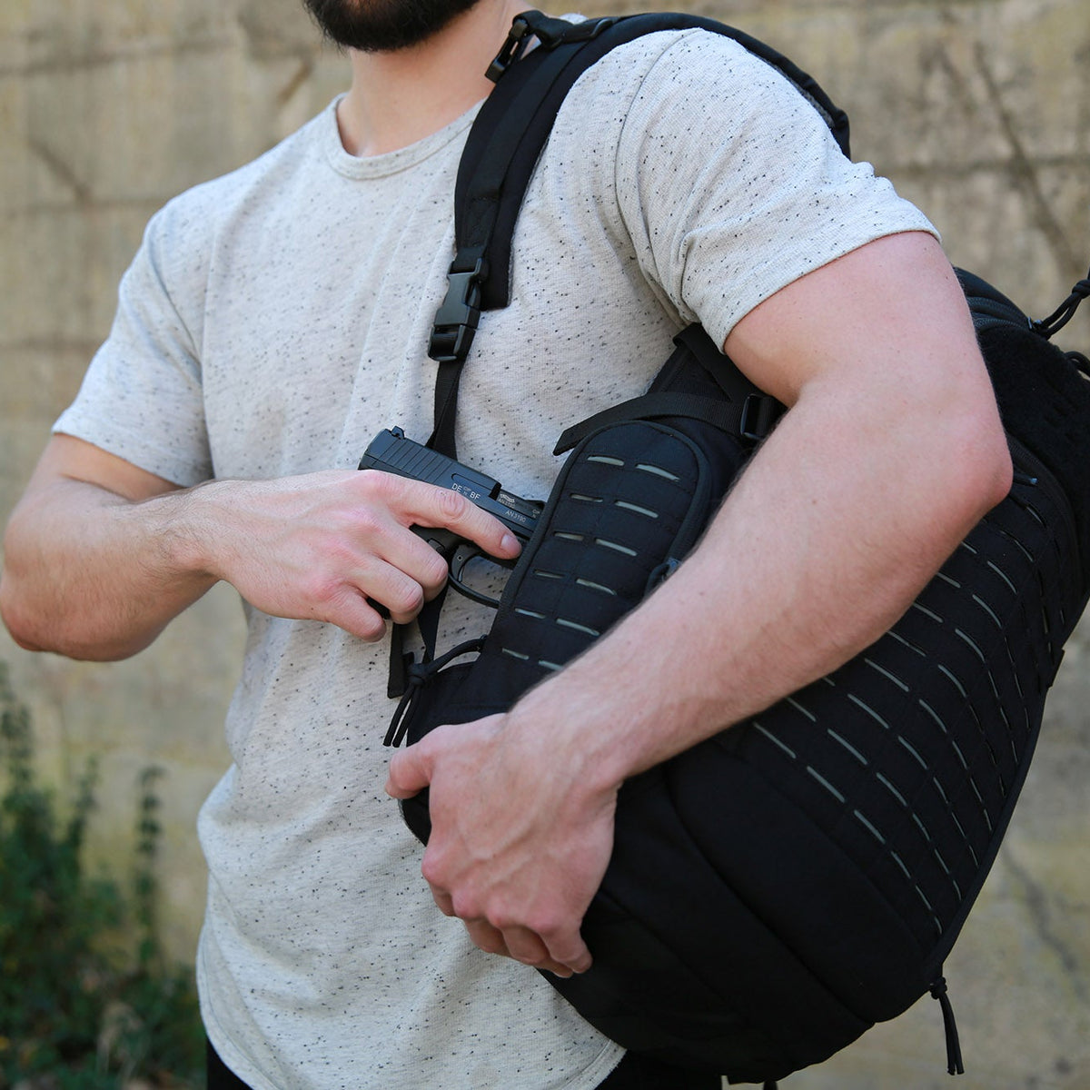 Firearm being drawn from CCW compartment of Guardian Backpack.