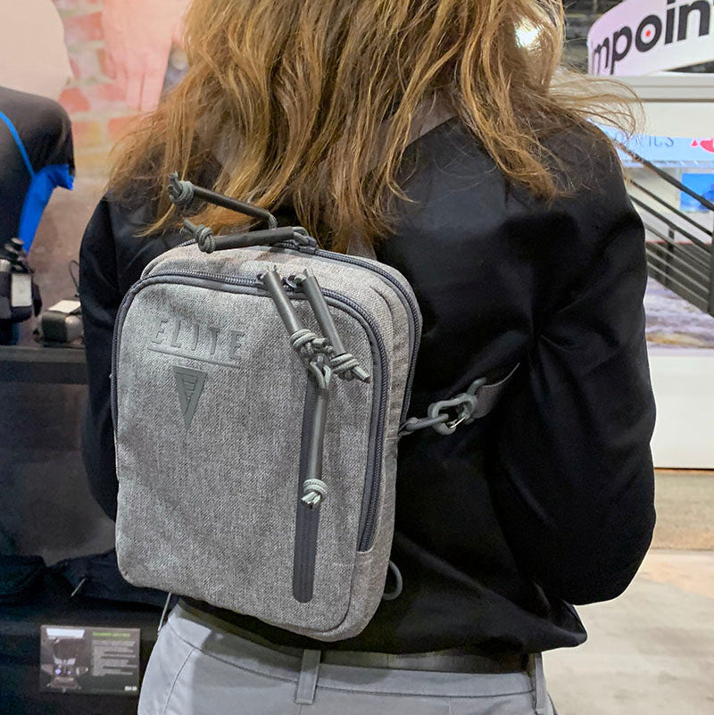 Avenger gun pack being worn backpack style in heather gray color.