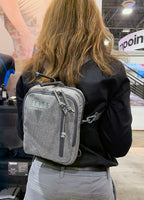 Avenger gun pack being worn backpack style in heather gray color.