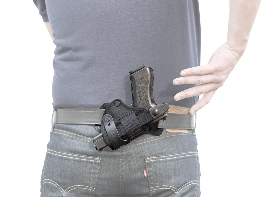 Man drawing gun from Advanced Back Holster