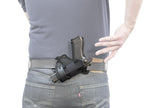 Man drawing gun from Advanced Back Holster