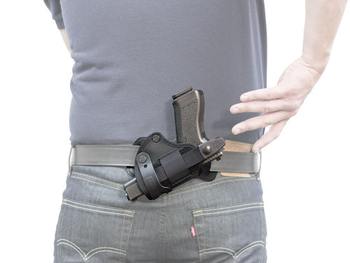 Man drawing gun from Advanced Back Holster