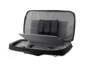 Interior shot of discreet rifle case with gray interior, hook and loop for attaching pouches, and a tie-down system for securing the firearm.