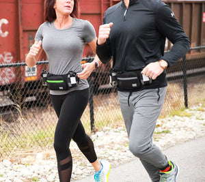Lady and man running with Marathon pack
