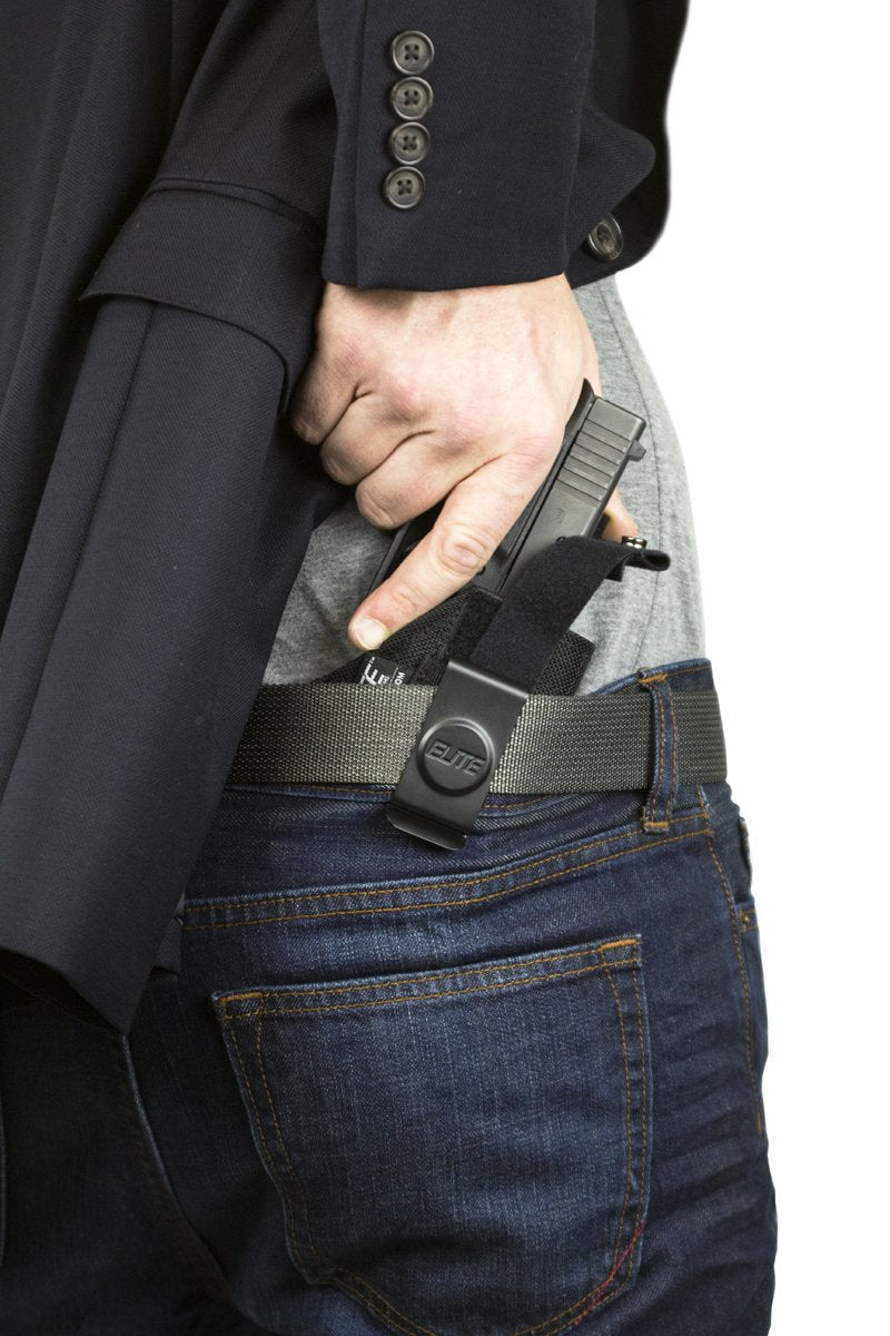 Man with gun tucked in pants Stock Photo by belchonock 117236766